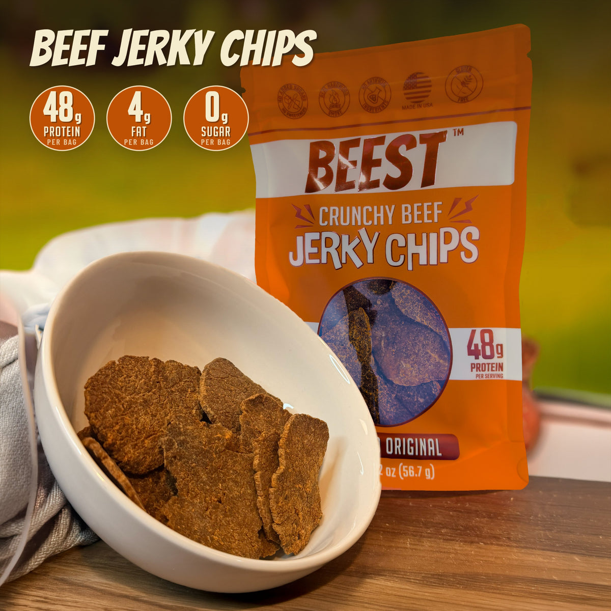 BEEST Beef Jerky Chips bag beside a bowl of chips: 48g protein, 4g fat and 0g sugar per bag