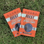 Two bags of BEEST Beef Jerky Chips, Smoked Original, fanned out on green grass