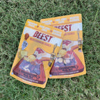 Two bags of BEEST Charcuterie Trail Mix, Mediterranean Crunch, crossed on green grass