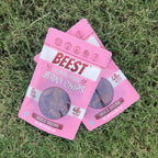 Two bags of BEEST Pork Jerky Chips, Smoked Original, crossed on green grass